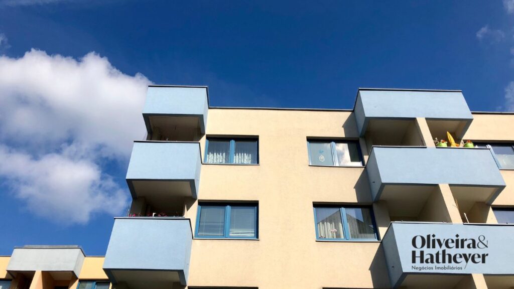Fachada de prédio residencial com varandas, representando imóveis urbanos e regras do mercado habitacional.